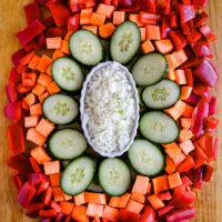 a cutting board with a variety of colorful vegetables that have been minced sliced diced and chopped